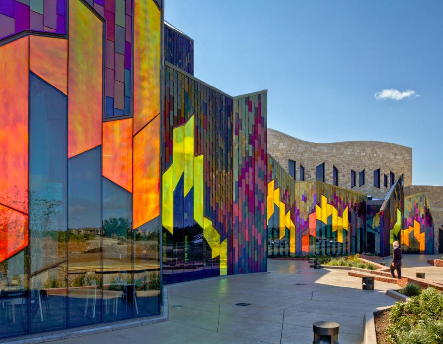 The Oslo A vibrant building featuring an array of colorful glass panels reflecting light in various hues.